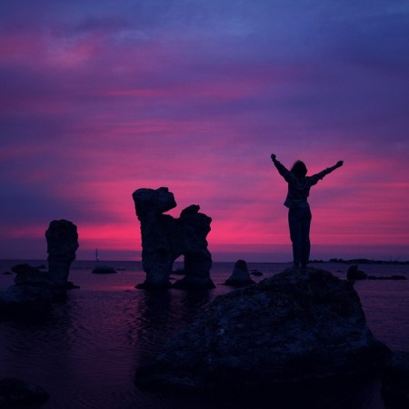cheering woman in sunset