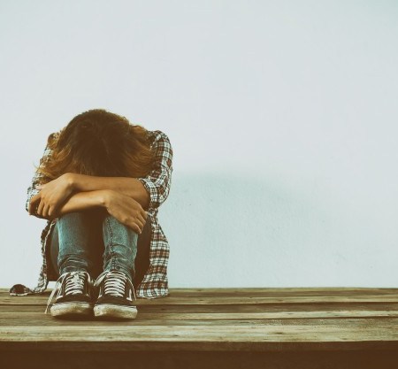 Woman Hunched Over Knees